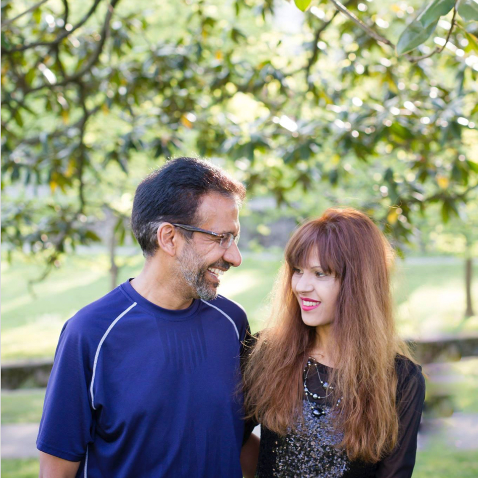 Couple posing under a tree